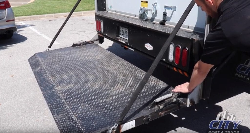 Man showing how to work a lift gate