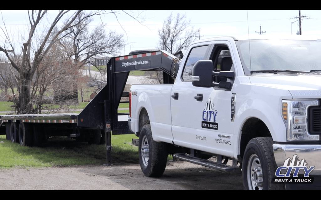 City Rent A Truck rental truck hauling a trailer