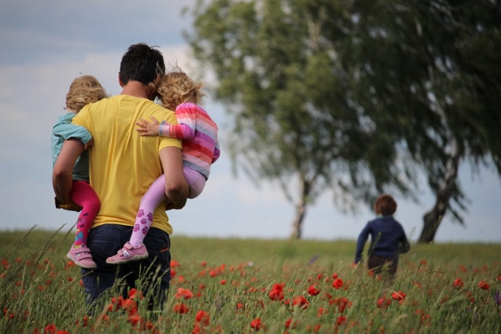 dad and children exploring outside